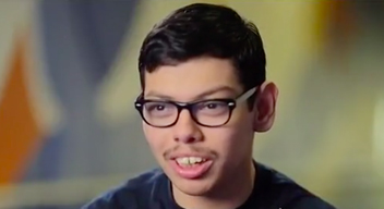 Picture of a male teen wearing glasses, talking to the camera