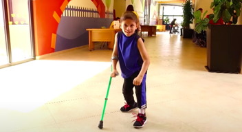 Picture of a smiling kid with crutches 